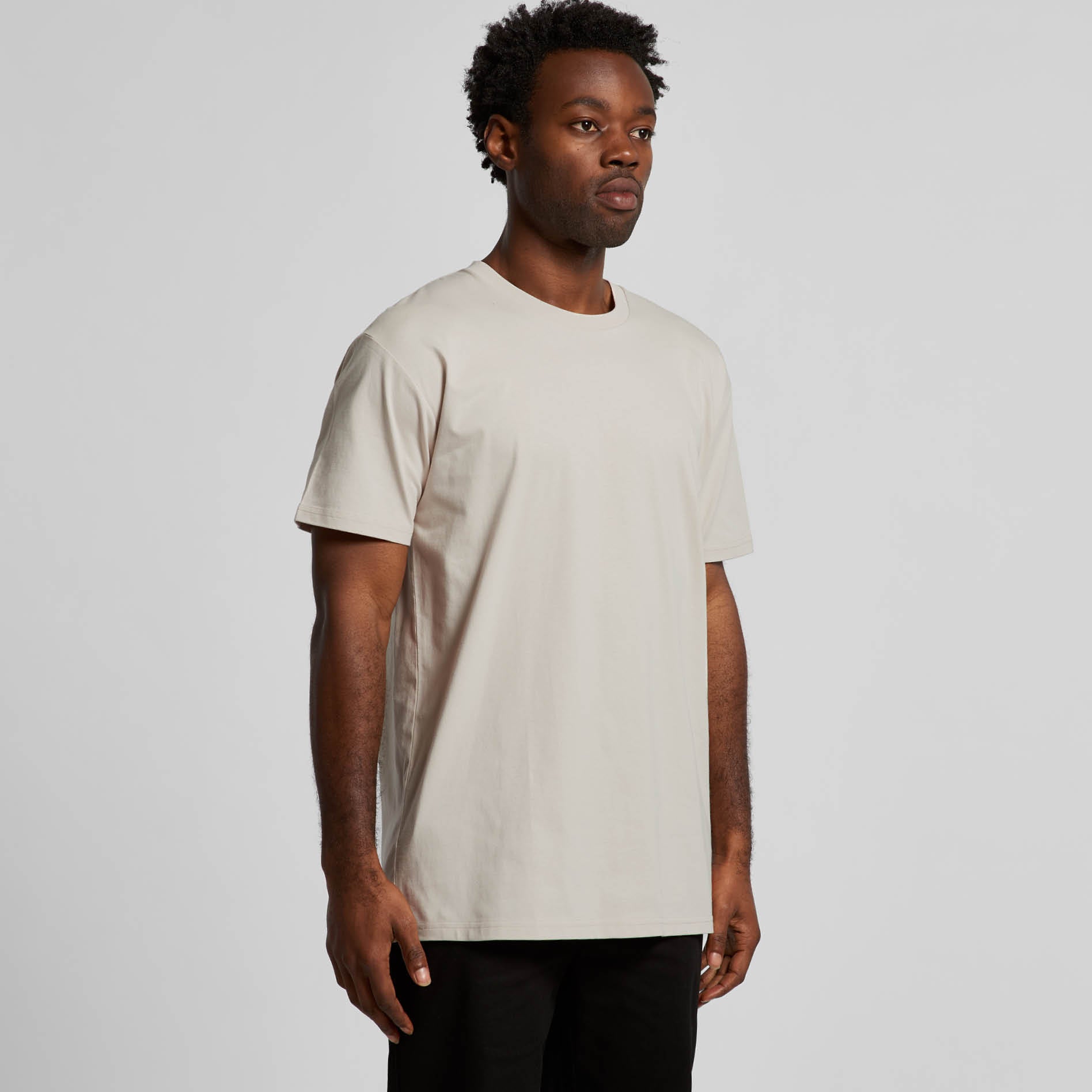 Customizable Unisex Staple Tee in Model Shot Side